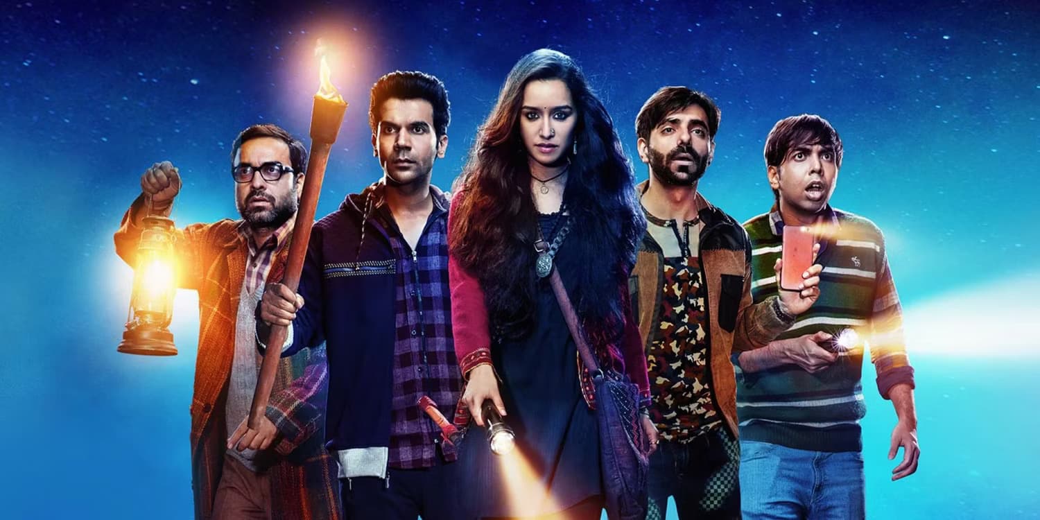 the-main-cast-of-stree-carrying-various-torches-and-flashlights-to-find-their-way-at-night